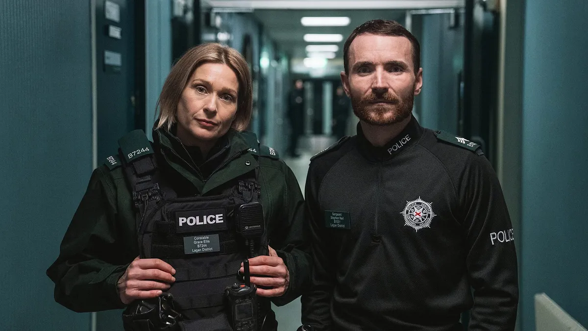 Two police officers stand by side facing the camera