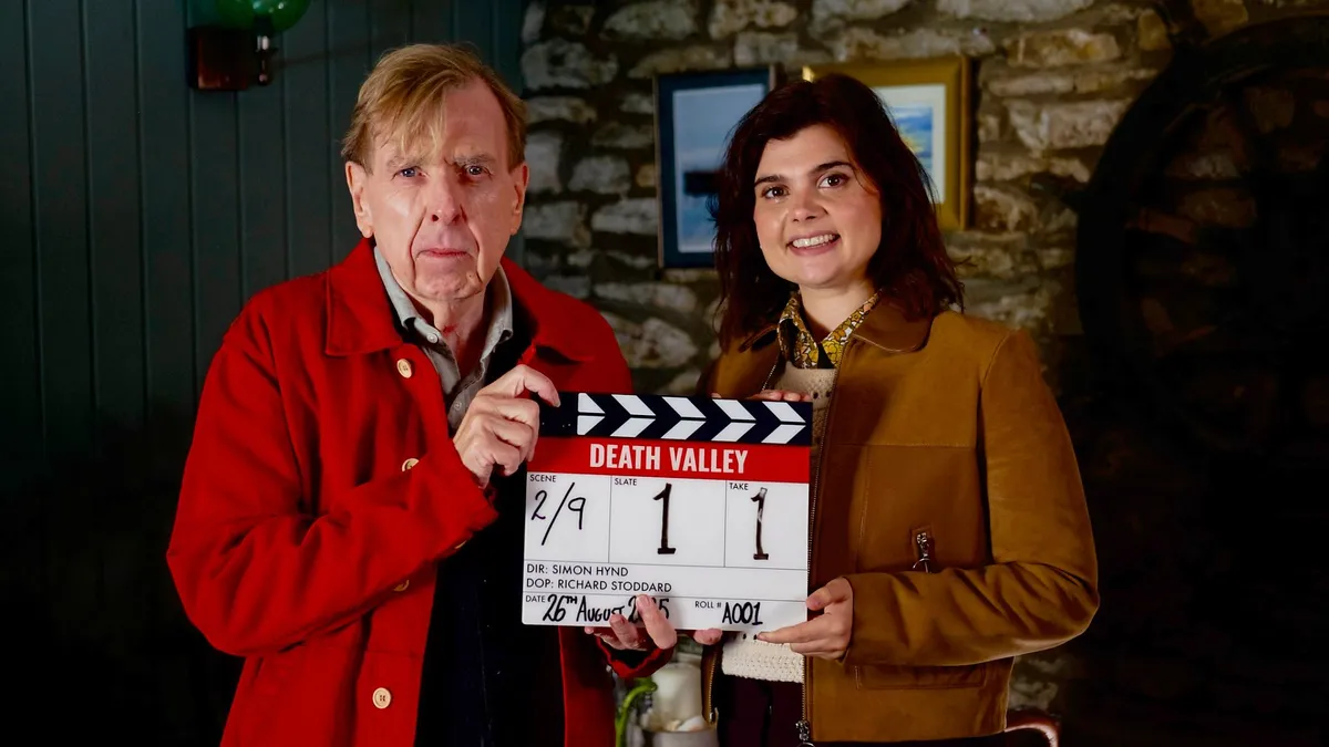 Timothy Spall and Gwyneth Keyworth holding a Death Valley clapperboard