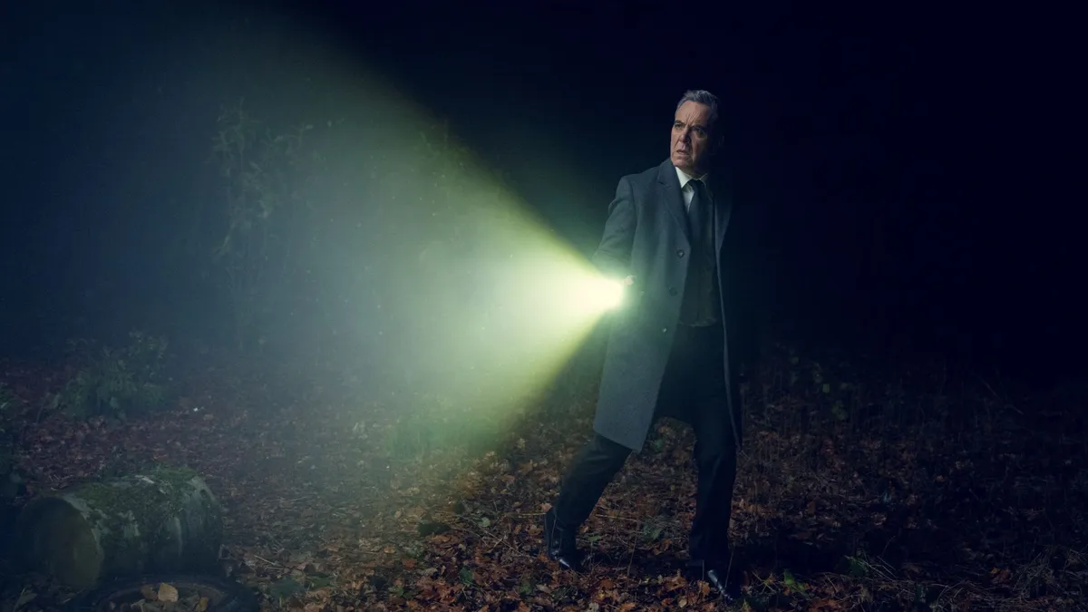 James Nesbitt as Simon Greene, search a dark forest by torchlight
