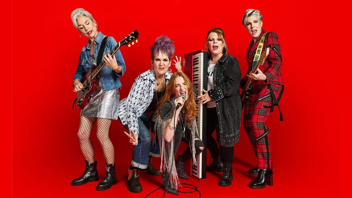 Group photo of the cast on a red background
