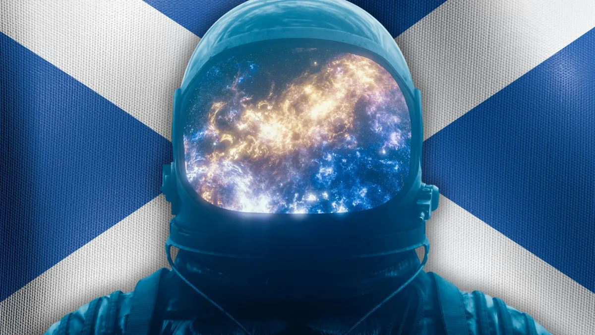 A person in a space suit in front of a Scottish flag