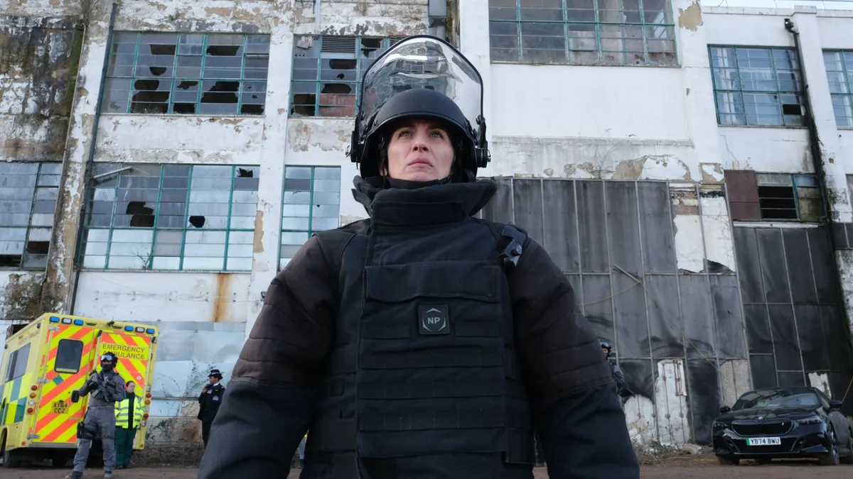 Vicky McClure as Lana Washington, dressed in a safety suit with an ambulance in the background